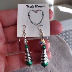 Christmas earrings.  Handmade.  Green pearls and Swarovski crystal stars at top.